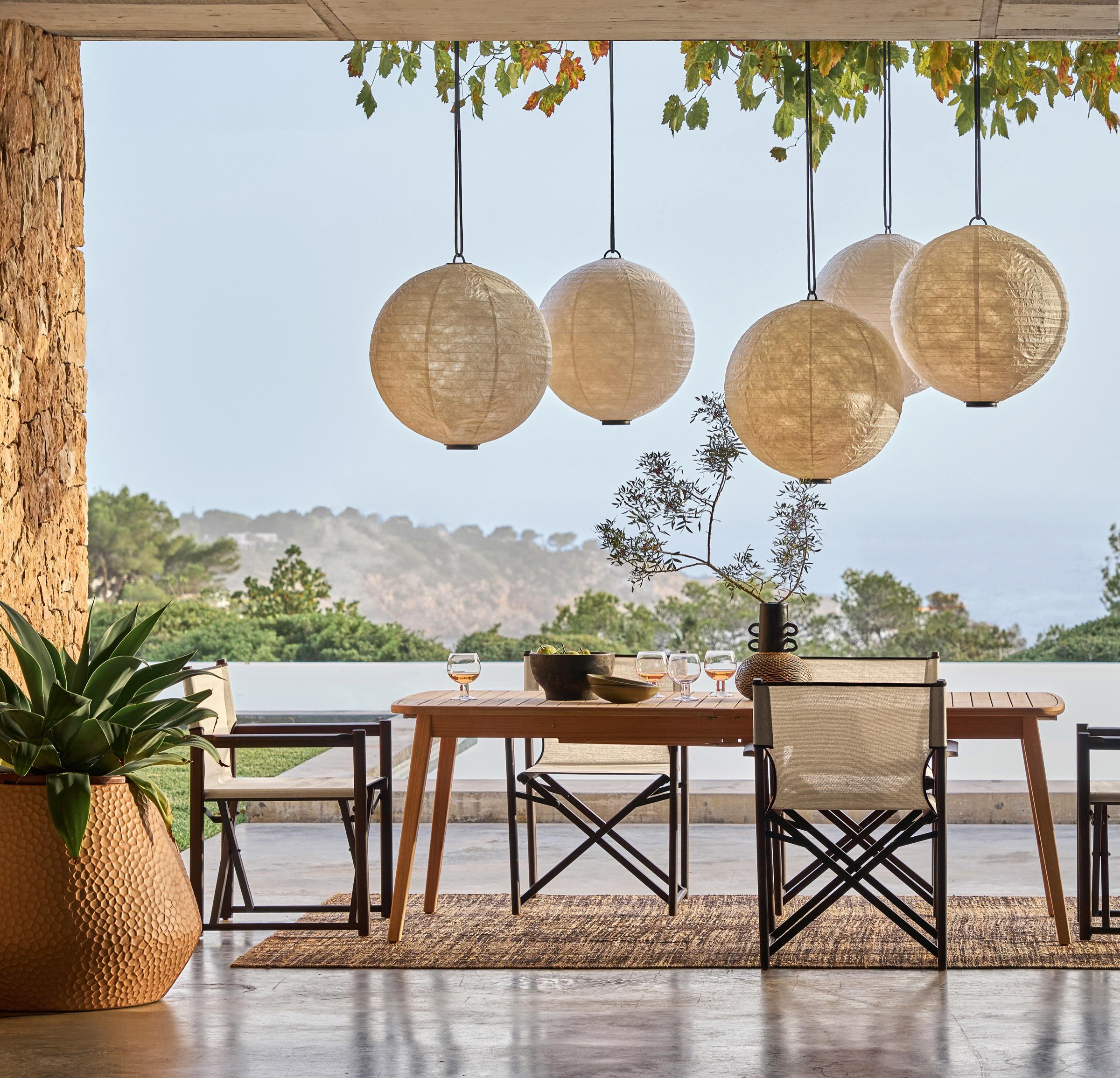 Outdoor space of a villa, outdoor furniture facing the landscape.